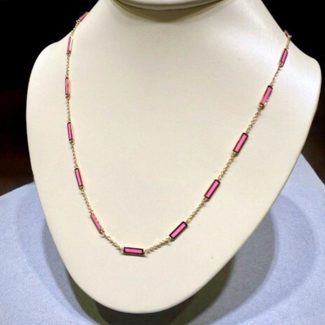 Frederick Sage 14K gold and pink enamel necklace displayed on a jewelry bust.