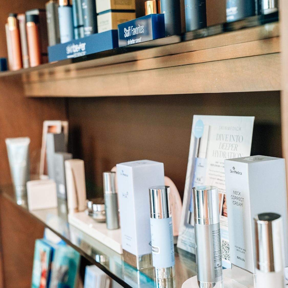 Close-up of a retail display shelf featuring an assortment of skincare products, including boxed items and bottles, arranged neatly with some informational signage visible in the background.